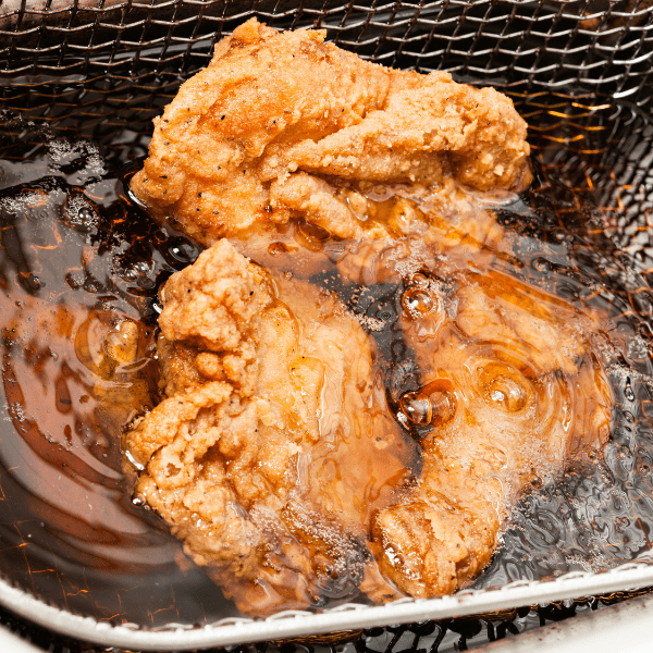Deep frying breaded chicken wings.