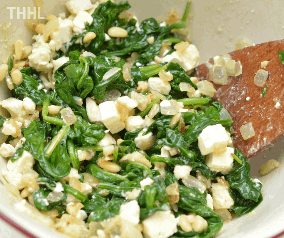 mixing with spinach and feta