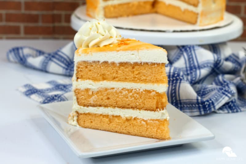 orange creamsicle cake on a white plate