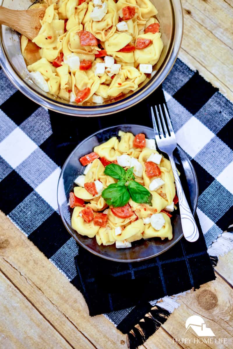 tortellini pasta salad on black checkered napkin