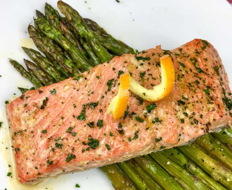 closeup of glazed salmon on asparagus