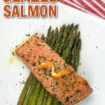 orange glazed salmon and asparagus on a white plate with red and white napkin