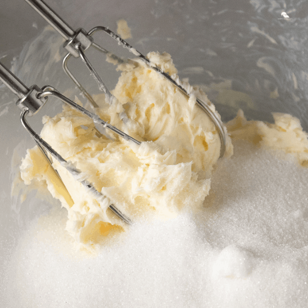 photo of butter and sugar being creamed with hand mixer