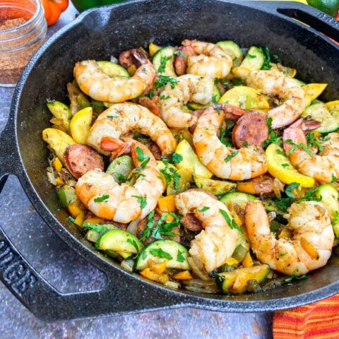 shrimp sausage and veggies in a cast iron pan