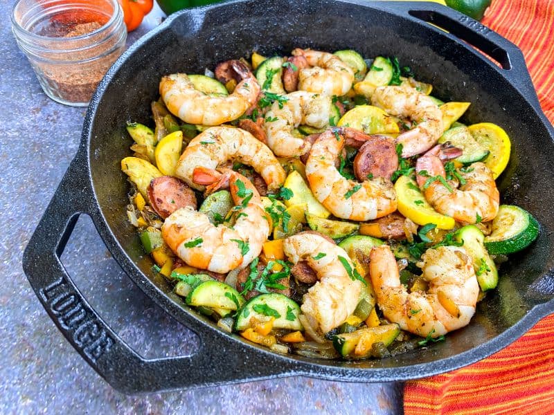 shrimp sausage and veggies in a cast iron pan