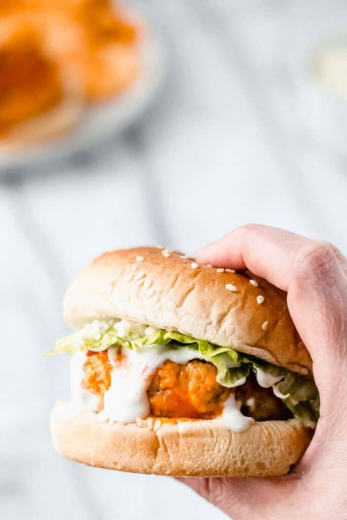 hand holding a buffalo chicken burger