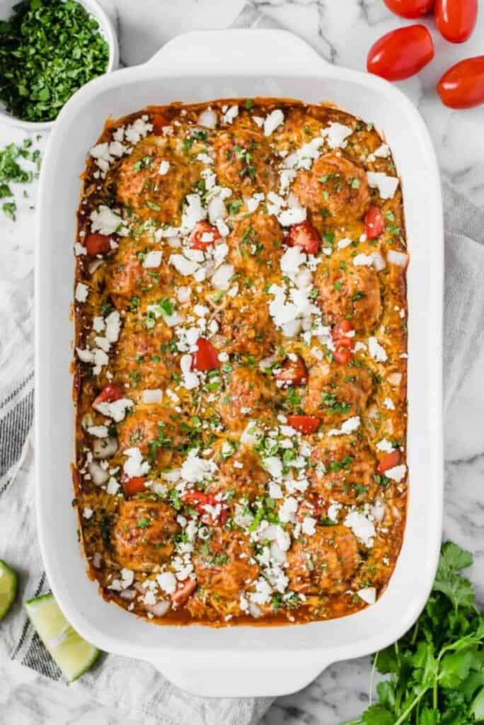 enchilada chicken meatballs in a white casserole dish