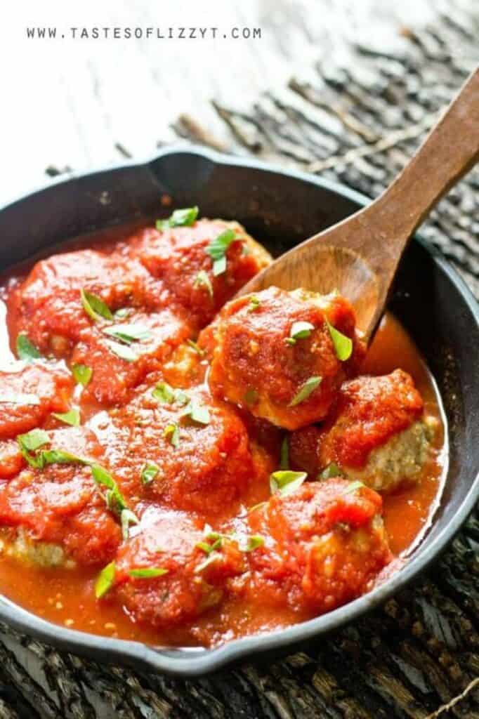 GF chicken parm meatballs in a cast iron skillet