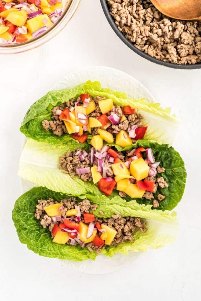 ground chicken tacos in a lettuce wrap