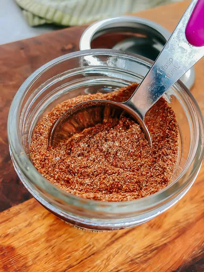 low carb taco seasoning mix in a jar with a measuring spoon
