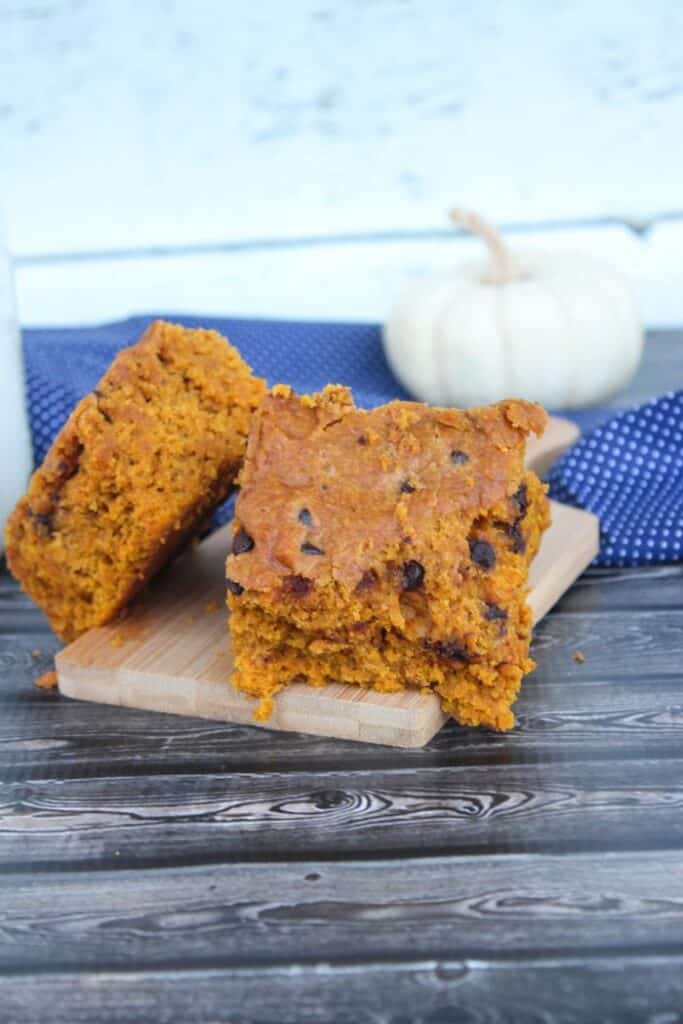 chewy pumpkin blondies cut into squares placed on a small cutting board
