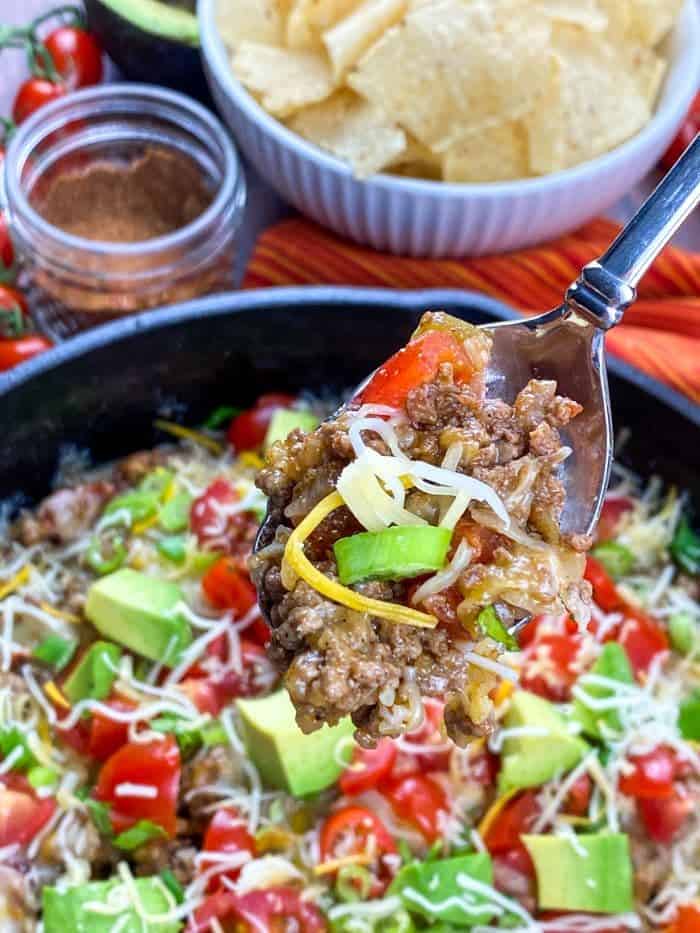 easy ground beef taco skillet with spoon of mixture in foreground