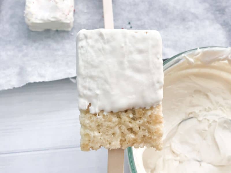 rice krispie treat dipped in white chocolate coated 3/4 of the way