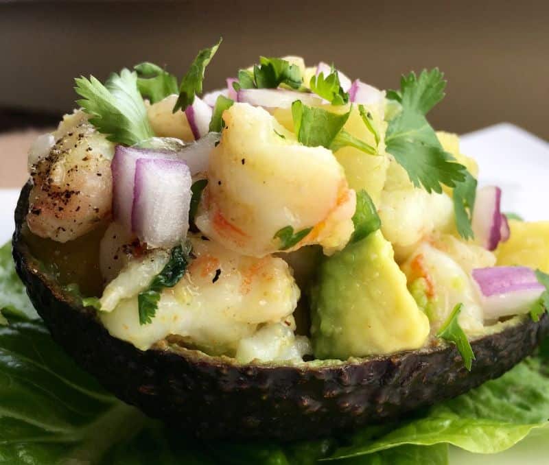 close-up picture of avocado shell stuffed with shrimp and pineapple mixture