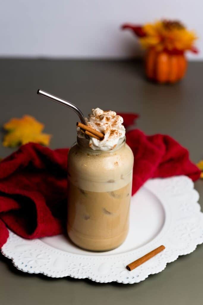 pumpkin spice latte vegan version in tall glass on white serving platter