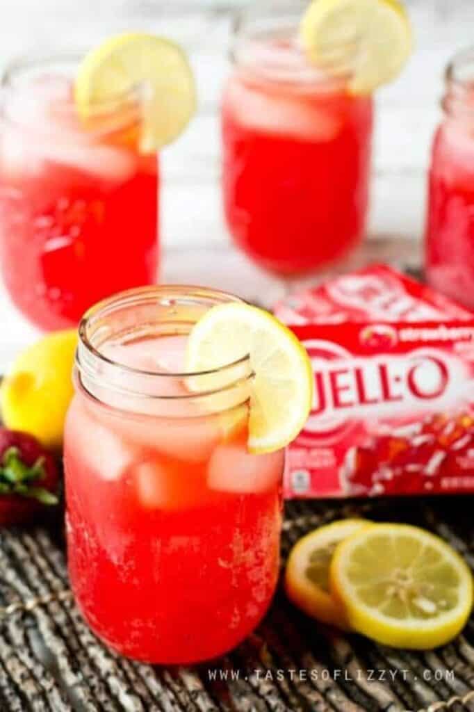 strawberry punch in mason jars garnished with lemon slices