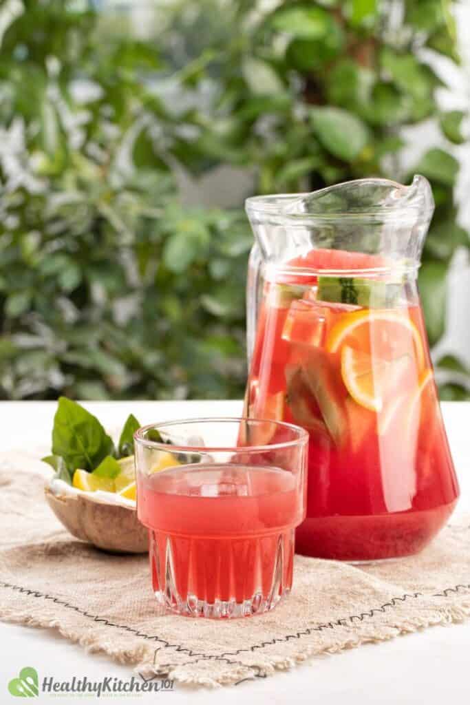 watermelon jungle juice in glass pitcher in outdoor setting