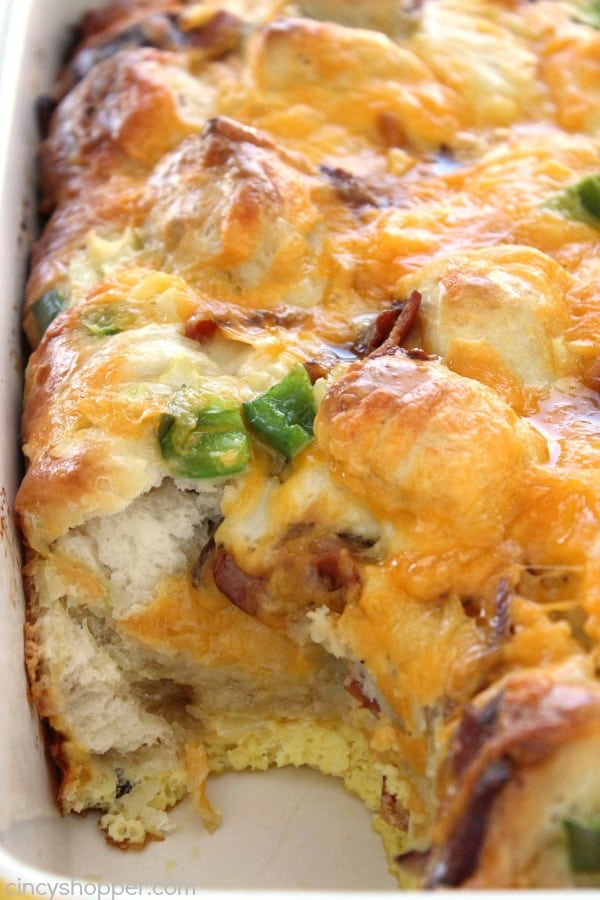 bacon egg and cheese biscuit casserole in white baking dish