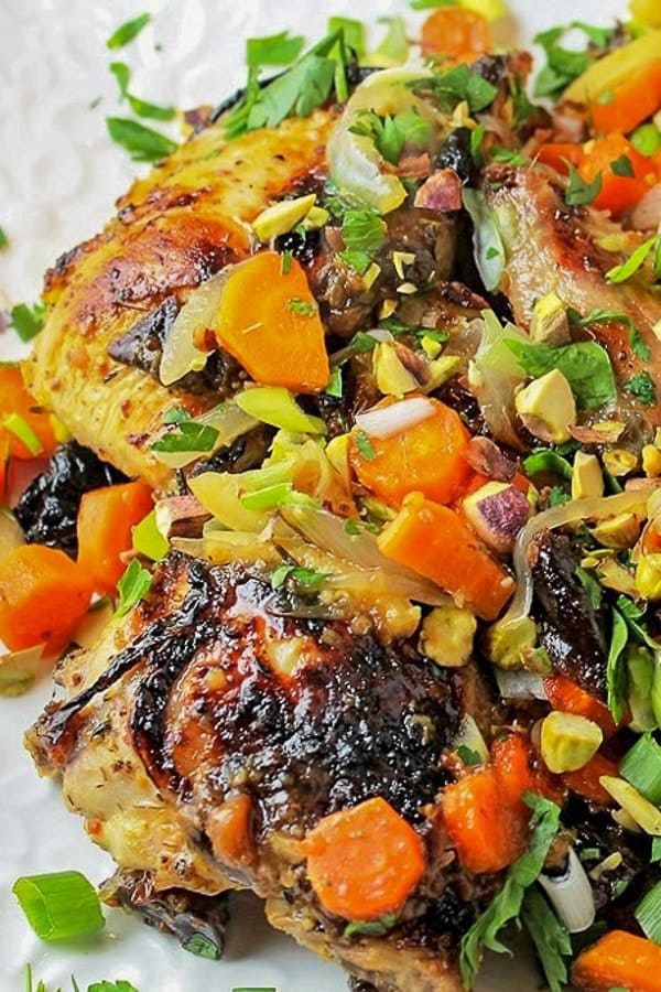 company chicken with carrots, pistachios, and other ingredients