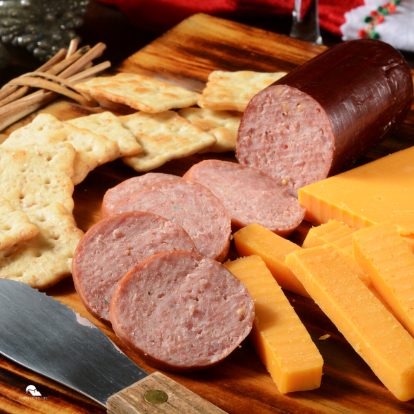 Sliced summer sausage with cheese and cheddar cheese.