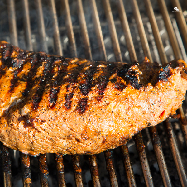 Tri-tip grilling on a hot BBQ grill.