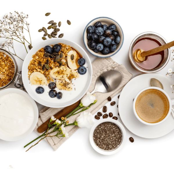Healthy breakfast set, oat granola with yogurt and honey.