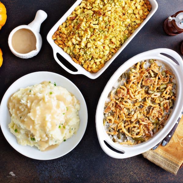 Typical Thanksgiving side dishes, mashed potatoes, green bean casserole and stuffing.