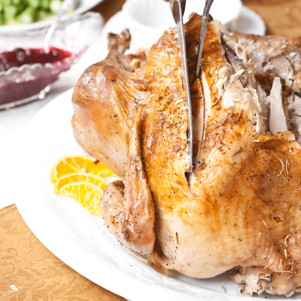 Can You Carve A Turkey Ahead of Time? - close-up of turkey being carved.