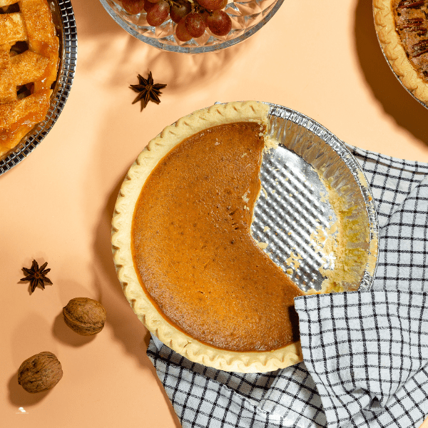 Thanksgiving pumpkin pie with a slice missing.