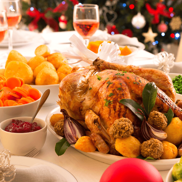 A traditional Christmas dinner with turkey, and cranberry sauce set on a table. 