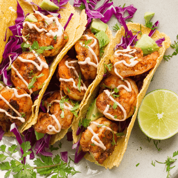 Gourmet shrimp tacos, plated and ready to eat.