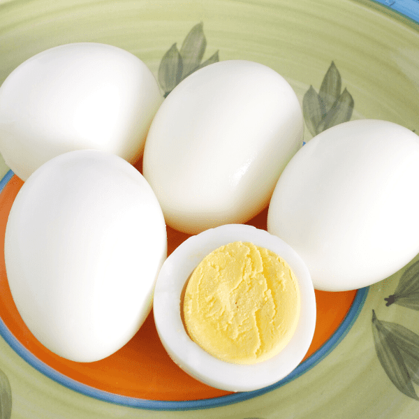 Hard boiled eggs on a green plate.