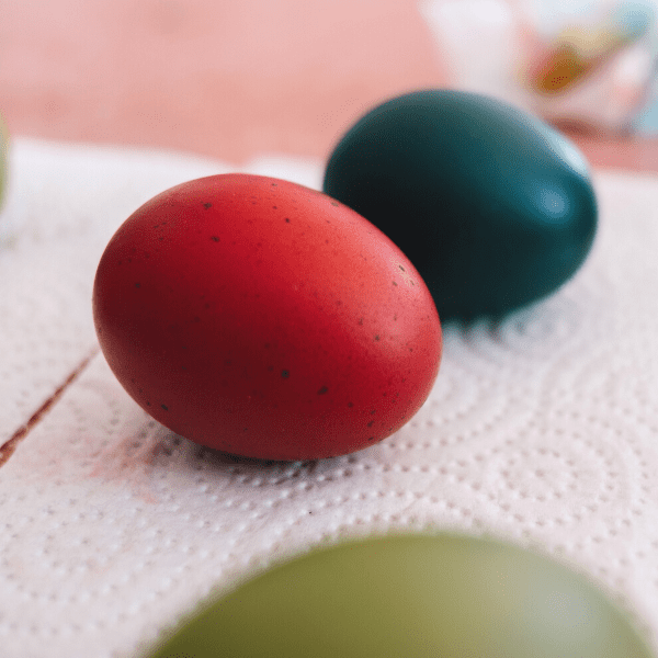 two hard boiled eggs color one in red and one in blue.