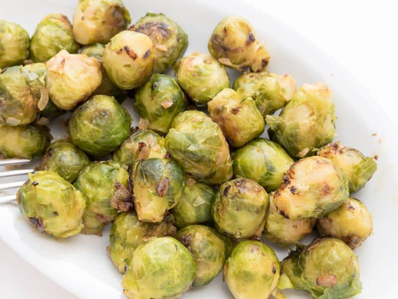 cooked brussel sprouts on a white dish