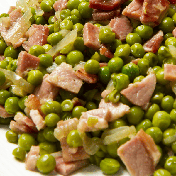 close up of peas and ham dinner.