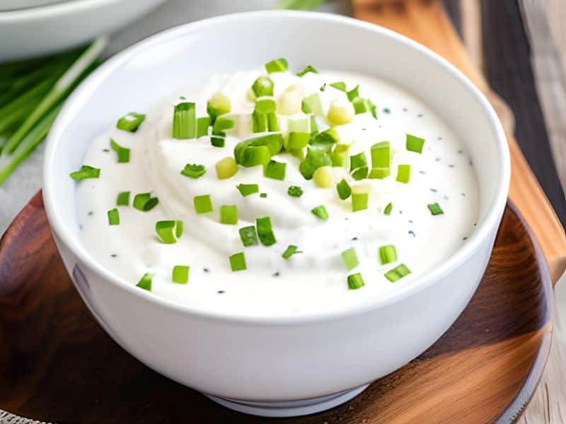 sour cream in a bowl with chives