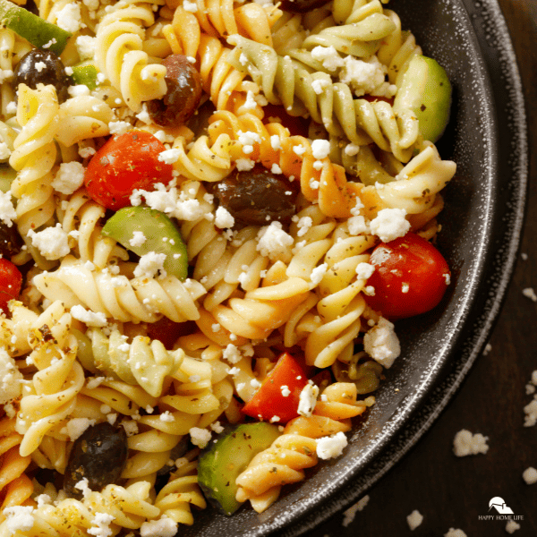 A close-up shot of a fall pasta salad on a black serving dish.