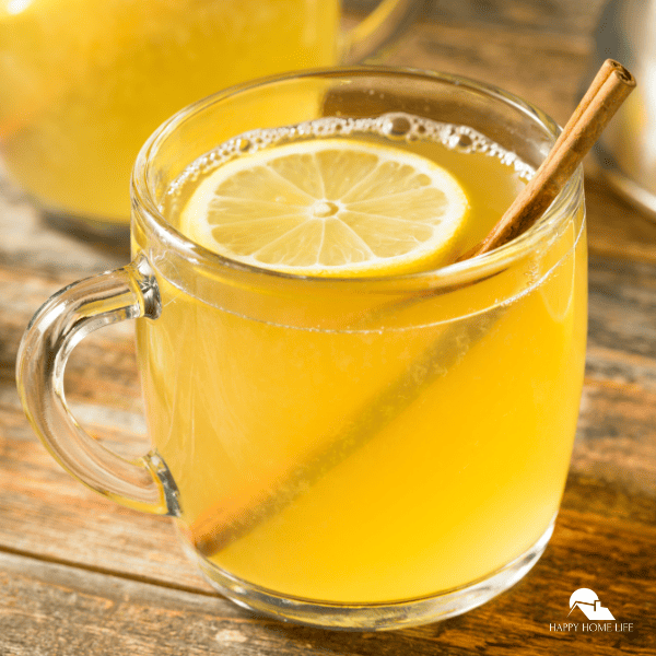 A close-up shot of a Hot Toddy cocktail with another cup in the background.