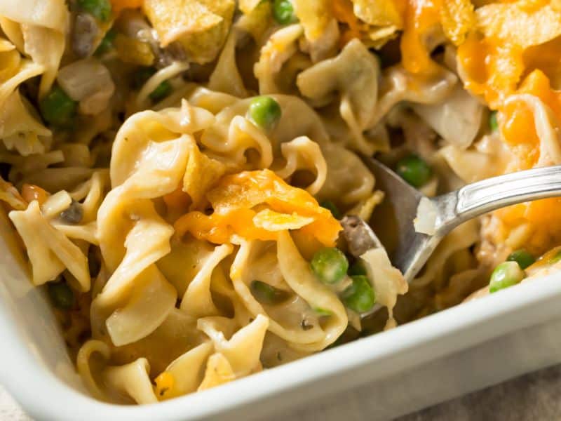 closeup shot of tuna casserole with noodles, peas, veggies, and tuna