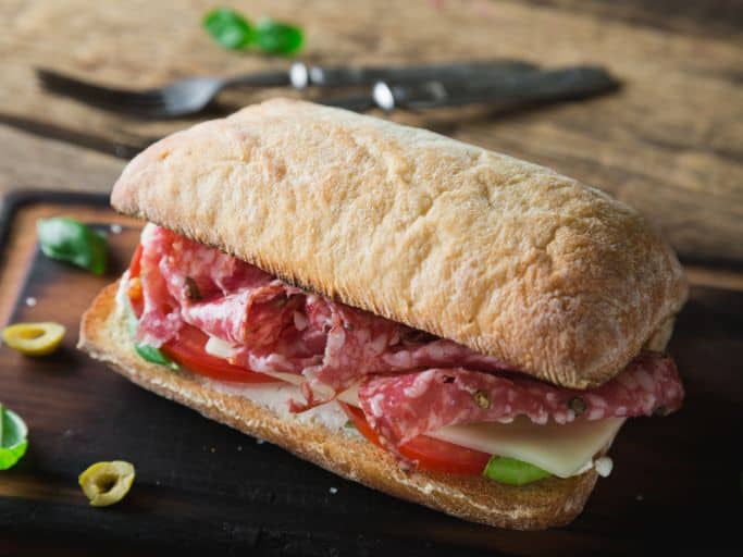 italian salami sandwich on cutting board