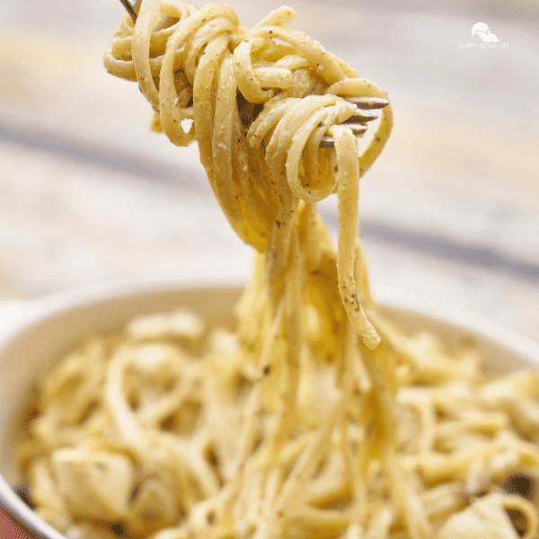  n image of a white pasta in a bowl with fork