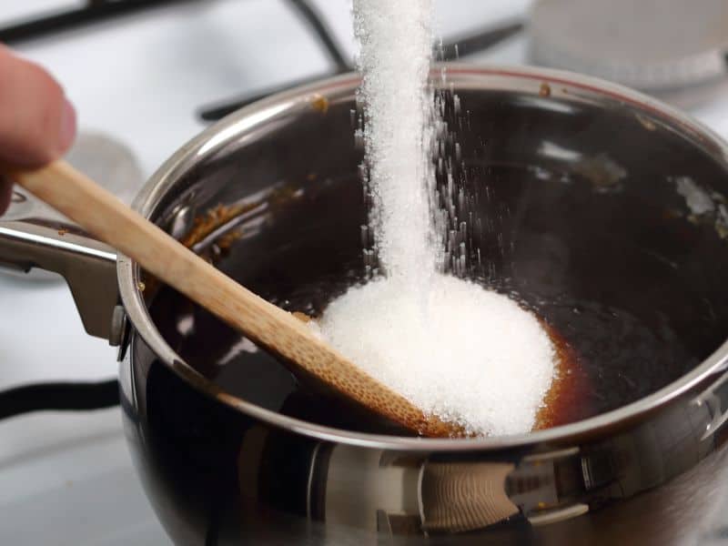 pouring sugar into a pot