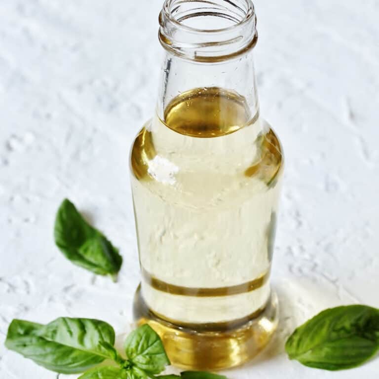 simple syrup in bottle surrounded by mint leaves