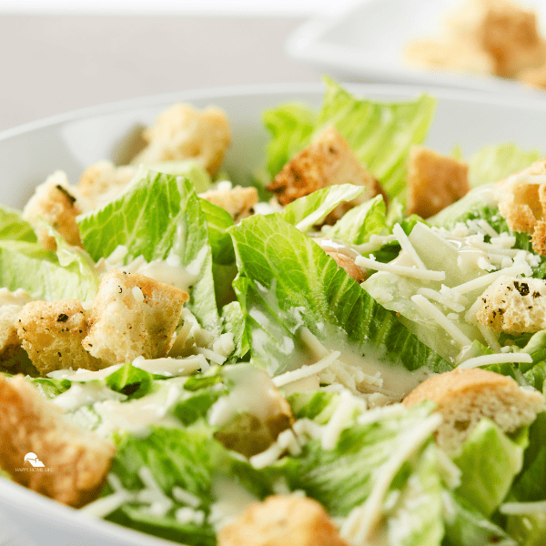 a close up image of caesar salad