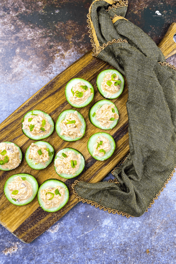 Spicy Tuna Cucumber Bites in a wooden chopper