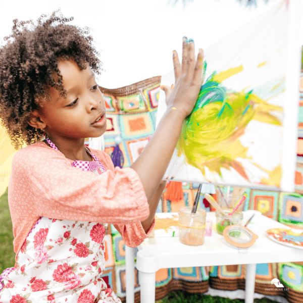 a kid trying to paint on a paper using the hand