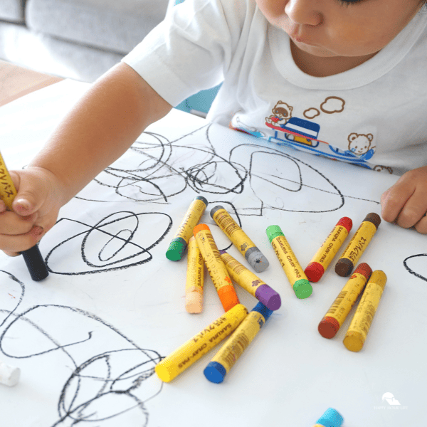 a boy holding an oil pastel