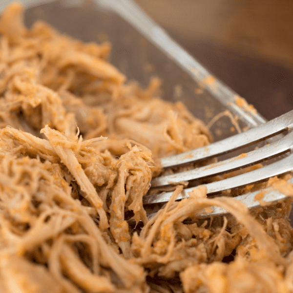 Close up of pulled pork with fork.