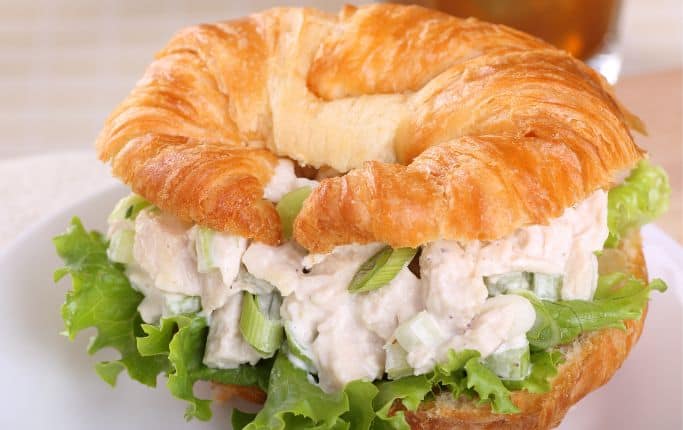 chicken salad on a croissant with lettuce