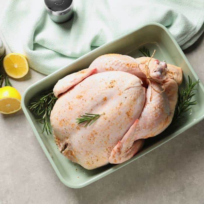 thawed turkey prepped in the pan